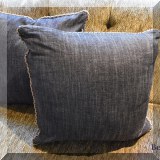 D055. Pair of custom down pillows in black with contrasting welt. 20” x 20” - $46 each